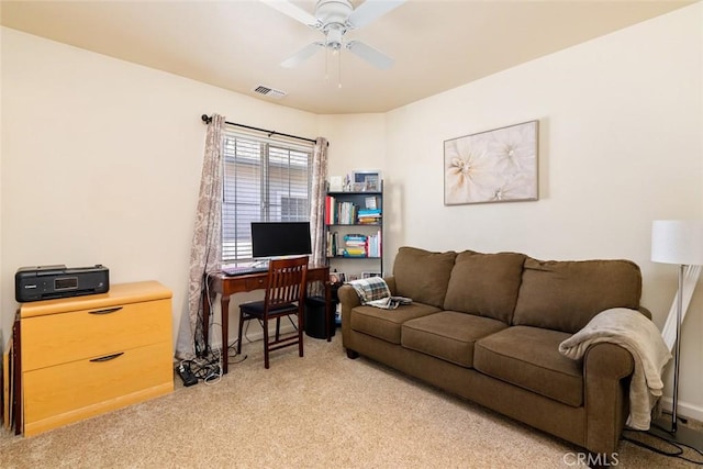 interior space with a ceiling fan, light colored carpet, and visible vents