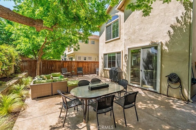 view of patio featuring a fenced backyard, outdoor dining space, an outdoor living space, and a grill