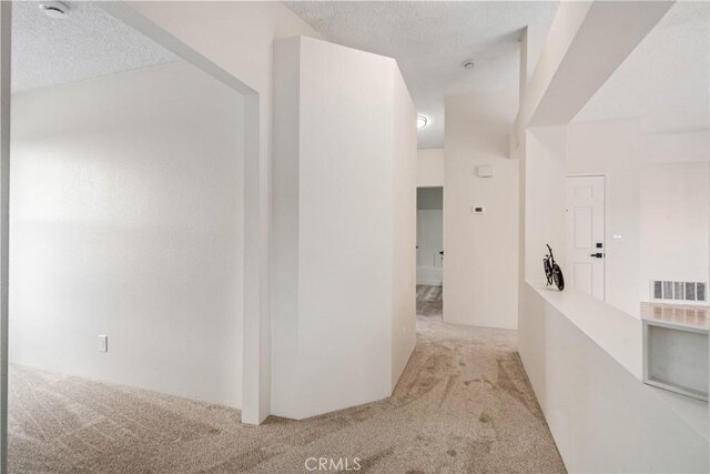 1148 Arlington Ct, Rosamond, CA 93560 - corridor featuring carpet floors, a textured ceiling, and visible vents
