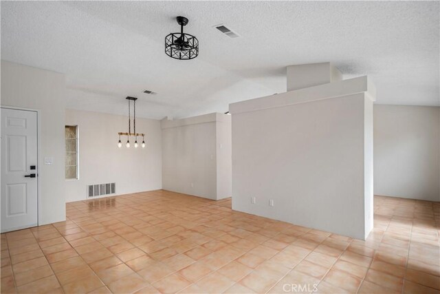 1148 Arlington Ct, Rosamond, CA 93560 - unfurnished room featuring a chandelier, visible vents, and vaulted ceiling