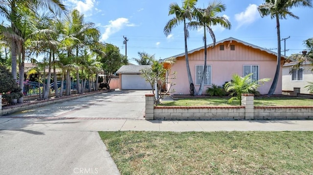 single story home featuring fence, stucco siding, concrete driveway, and a front yard