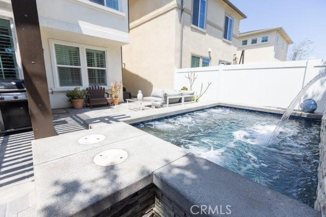 2630 Luminous Ln, Costa Mesa, CA 92626 - view of pool with an outdoor hot tub, fence, and a patio area