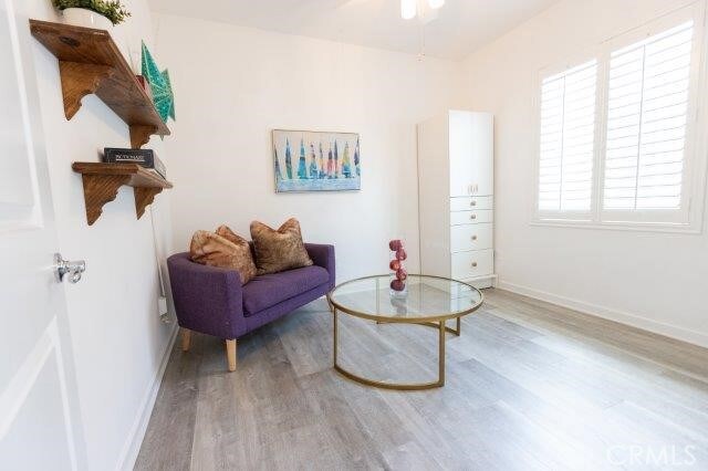 2630 Luminous Ln, Costa Mesa, CA 92626 - living area featuring light wood-style flooring, baseboards, and ceiling fan