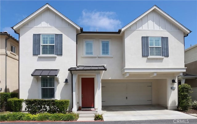 2630 Luminous Ln, Costa Mesa, CA 92626 - view of front of home featuring board and batten siding, stucco siding, an attached garage, and driveway