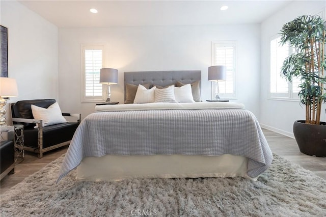2630 Luminous Ln, Costa Mesa, CA 92626 - bedroom featuring multiple windows, wood finished floors, recessed lighting, and baseboards