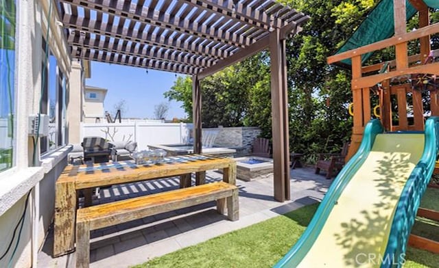 2630 Luminous Ln, Costa Mesa, CA 92626 - view of patio featuring an outdoor living space with a fire pit and fence