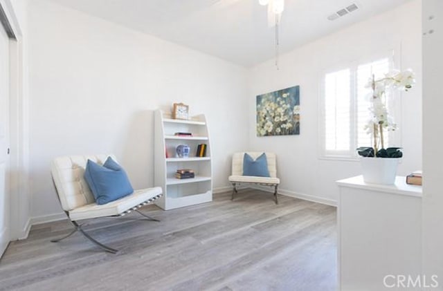 2630 Luminous Ln, Costa Mesa, CA 92626 - sitting room featuring wood finished floors, baseboards, and a ceiling fan