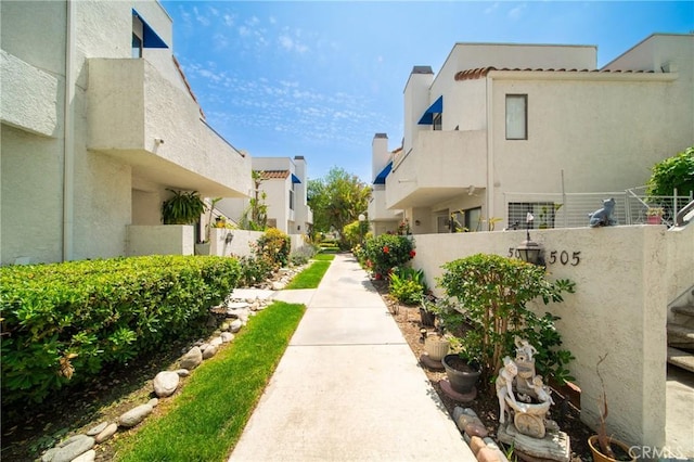 surrounding community with fence and a residential view
