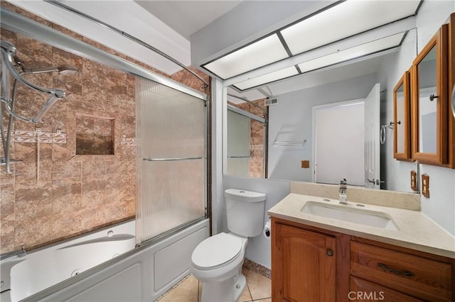 full bathroom with visible vents, vanity, tile patterned floors, toilet, and shower / bath combination with glass door