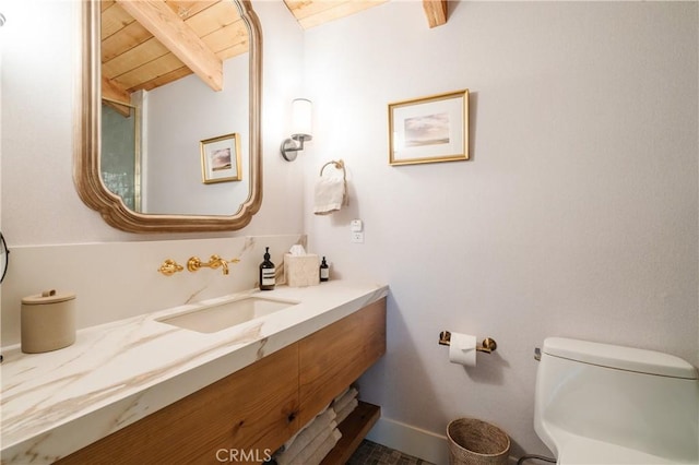 28805 N Shore Rd, Lake Arrowhead, CA 92352 - bathroom with vanity, toilet, baseboards, wooden ceiling, and beamed ceiling