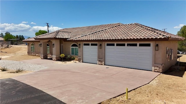 view of front of property with an attached garage, stucco siding, driveway, and stone siding