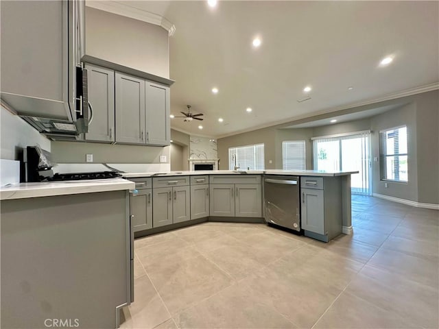 kitchen with a ceiling fan, crown molding, gray cabinetry, a peninsula, and stainless steel appliances