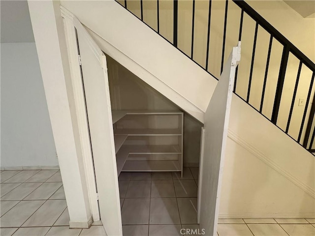 staircase featuring tile patterned floors