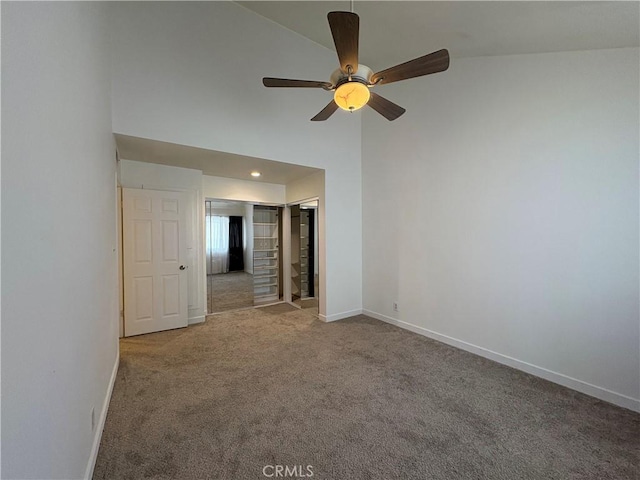 carpeted empty room with ceiling fan, baseboards, recessed lighting, and high vaulted ceiling