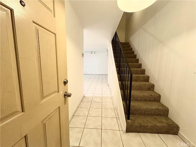 staircase featuring tile patterned flooring