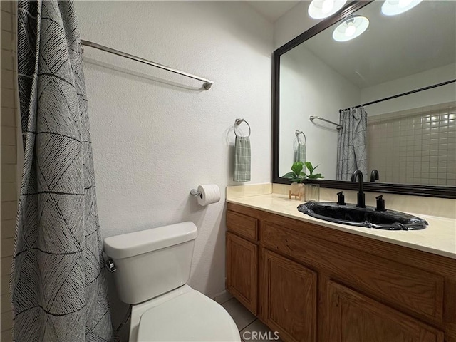 bathroom featuring toilet, vanity, and a shower with shower curtain