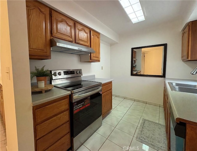 kitchen featuring stainless steel electric stove, under cabinet range hood, a sink, and brown cabinetry