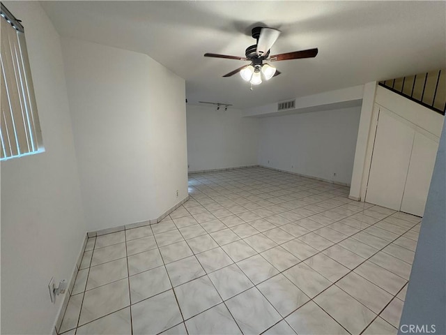 additional living space featuring ceiling fan and light tile patterned floors