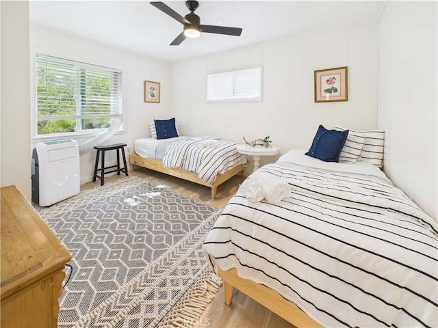 bedroom with ceiling fan and wood finished floors