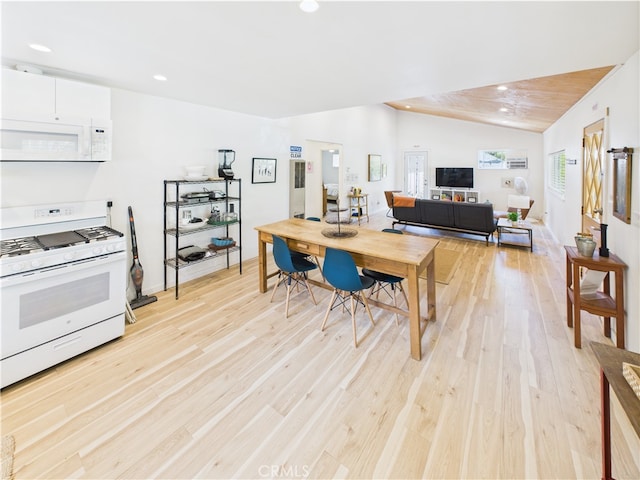 kitchen featuring recessed lighting, light wood-style flooring, vaulted ceiling, and white appliances