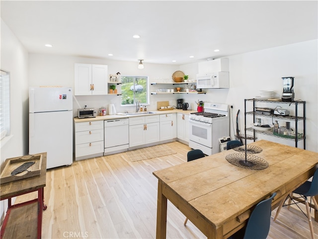 kitchen with open shelves, a sink, white appliances, and white cabinetry