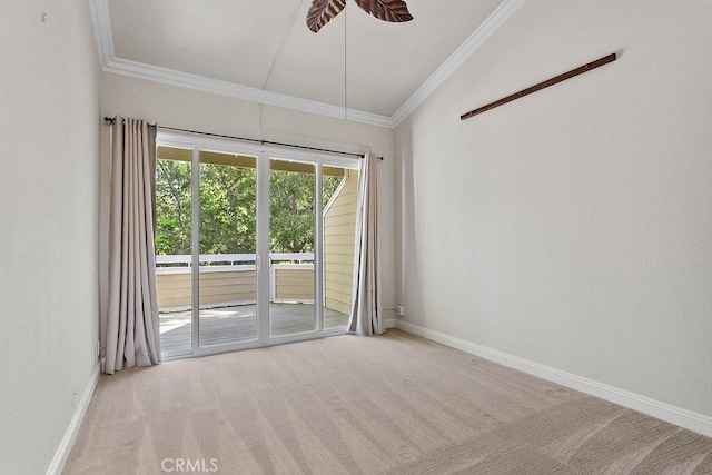 carpeted empty room featuring crown molding and baseboards