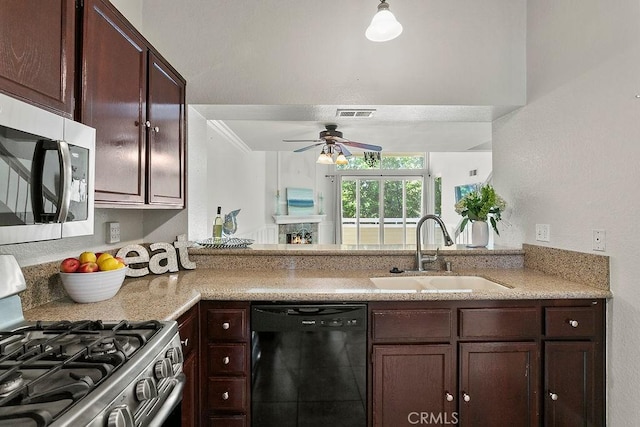 kitchen featuring a ceiling fan, dark brown cabinetry, appliances with stainless steel finishes, and a sink