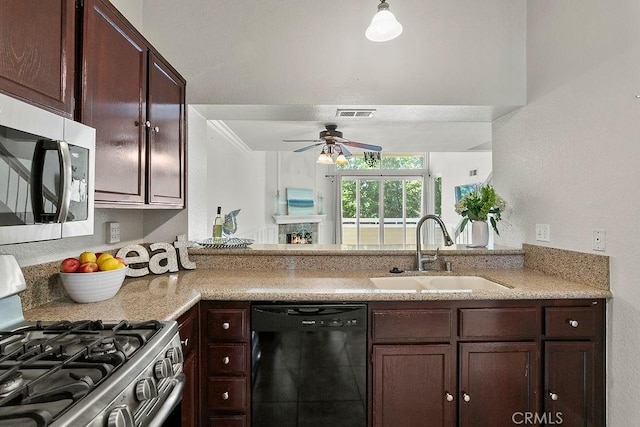 3630 S Bear St Unit 67, Santa Ana, CA 92704 - kitchen with stainless steel appliances, dark brown cabinetry, ceiling fan, and light stone countertops