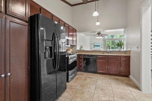 kitchen featuring ceiling fan, a towering ceiling, a sink, black appliances, and light tile patterned flooring