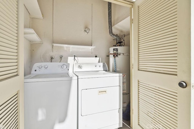 laundry room featuring laundry area, water heater, and washer and dryer