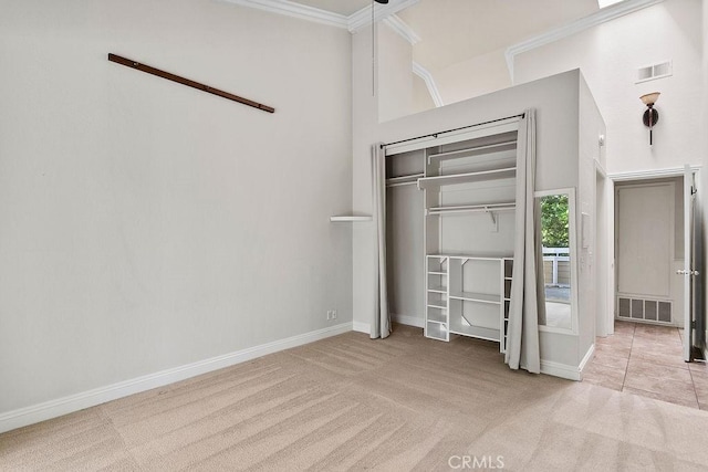 3630 S Bear St Unit 67, Santa Ana, CA 92704 - unfurnished bedroom featuring carpet floors, crown molding, and a closet