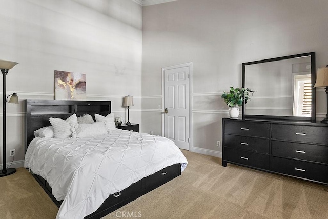 3630 S Bear St Unit 67, Santa Ana, CA 92704 - bedroom with light carpet, a high ceiling, and crown molding