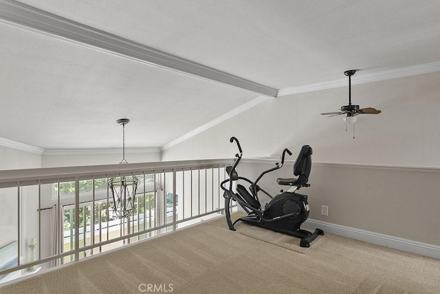 workout area featuring carpet floors, ornamental molding, baseboards, a ceiling fan, and vaulted ceiling