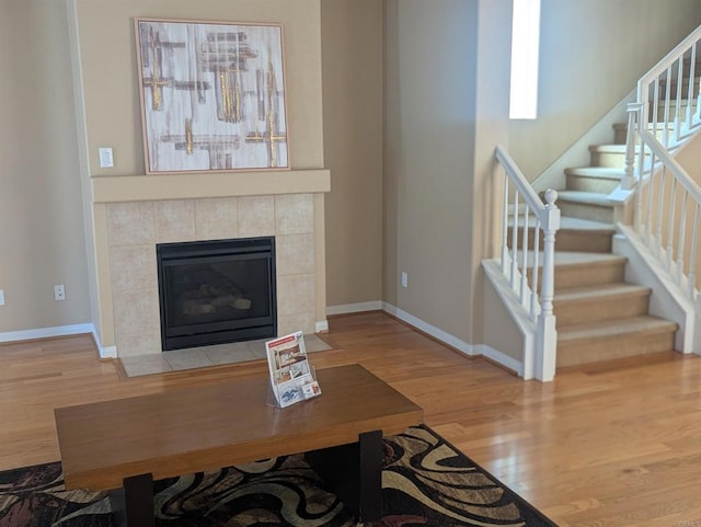 1703 Oconnor Ave, Chula Vista, CA 91913 - unfurnished living room featuring wood finished floors, stairway, and a tiled fireplace