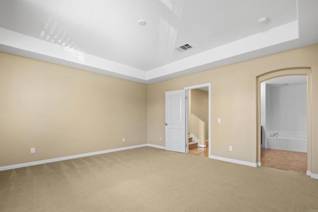 1703 Oconnor Ave, Chula Vista, CA 91913 - unfurnished bedroom with light colored carpet, a tray ceiling, arched walkways, and ensuite bath