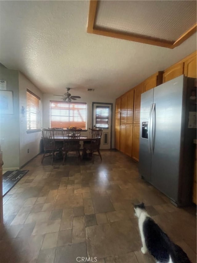 dining room with a textured ceiling and ceiling fan