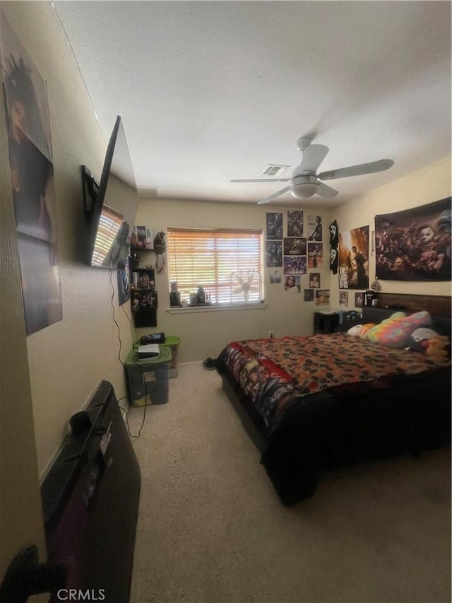 carpeted bedroom featuring visible vents and ceiling fan