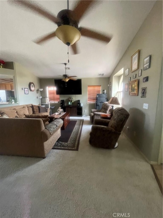 living area featuring plenty of natural light, a ceiling fan, carpet, and visible vents