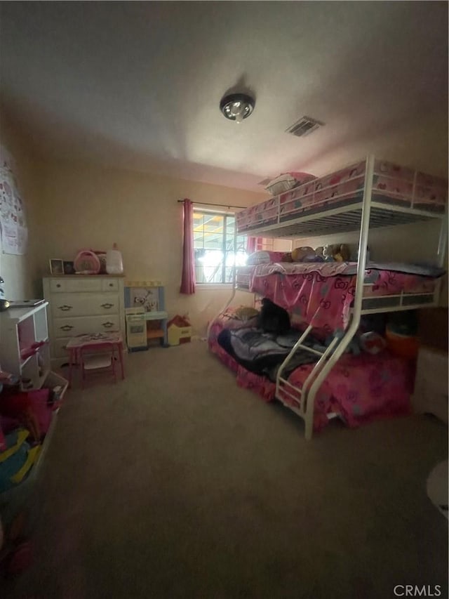 carpeted bedroom featuring visible vents