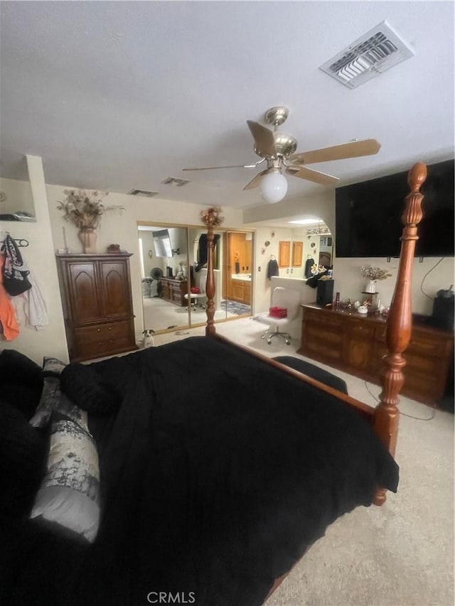 bedroom featuring visible vents, a ceiling fan, and carpet floors