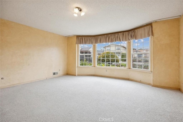 2132 El Dorado St, Los Osos, CA 93402 - carpeted spare room with visible vents, a textured ceiling, and baseboards