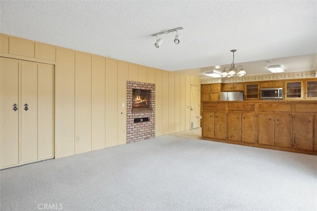 2132 El Dorado St, Los Osos, CA 93402 - unfurnished living room with light colored carpet, a chandelier, and a textured ceiling