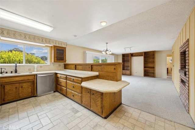 2132 El Dorado St, Los Osos, CA 93402 - kitchen with dishwasher, a peninsula, brown cabinetry, light countertops, and a chandelier