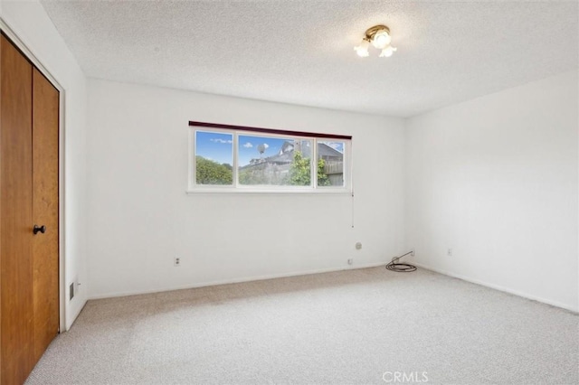 2132 El Dorado St, Los Osos, CA 93402 - unfurnished bedroom with light colored carpet, a textured ceiling, and a closet