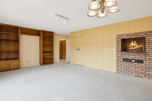 2132 El Dorado St, Los Osos, CA 93402 - unfurnished living room with carpet, a chandelier, a fireplace, and a textured ceiling