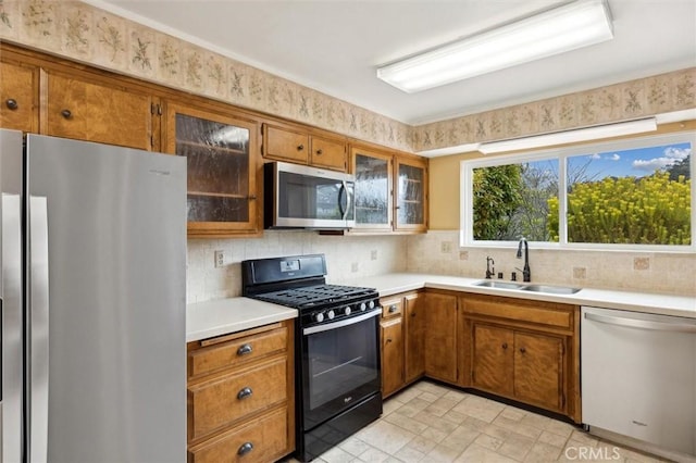 2132 El Dorado St, Los Osos, CA 93402 - kitchen with a sink, light countertops, brown cabinetry, and stainless steel appliances