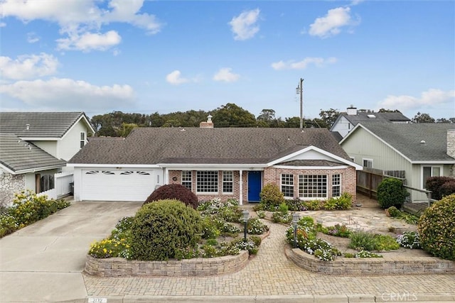2132 El Dorado St, Los Osos, CA 93402 - view of front of house with brick siding, an attached garage, concrete driveway, and a chimney