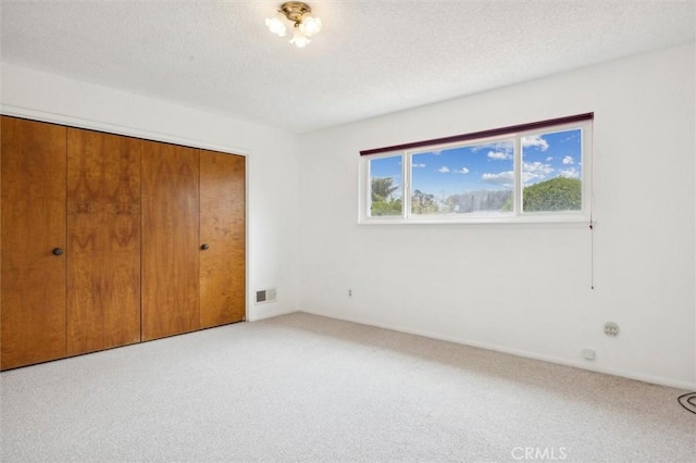 2132 El Dorado St, Los Osos, CA 93402 - unfurnished bedroom with light carpet, a closet, and a textured ceiling
