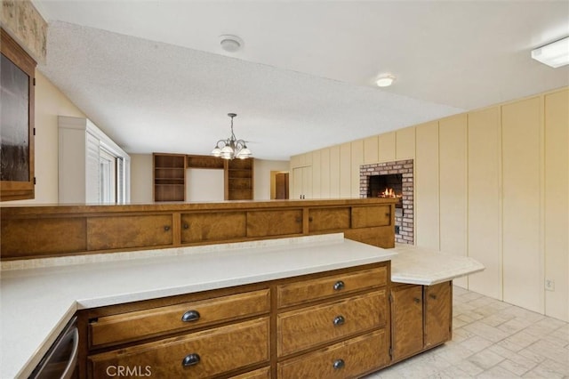 2132 El Dorado St, Los Osos, CA 93402 - kitchen featuring light countertops, brown cabinetry, an inviting chandelier, and pendant lighting