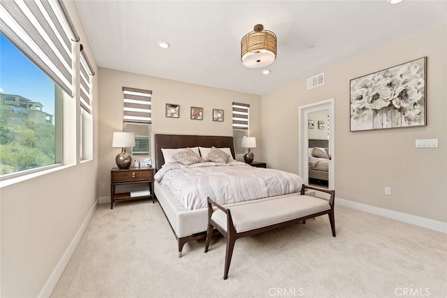 bedroom featuring baseboards, light carpet, recessed lighting, and visible vents